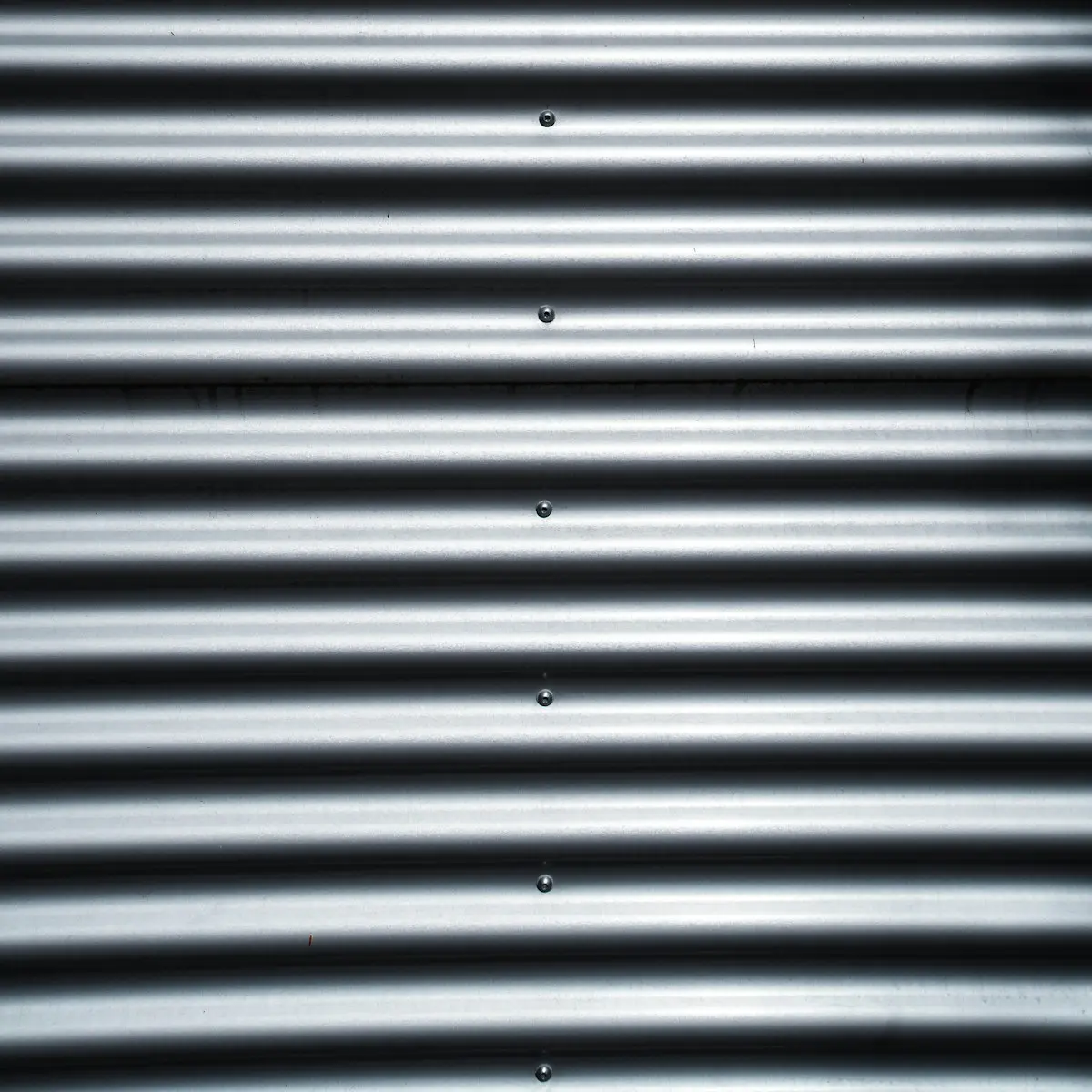 Galvanised corrugated iron striped with shadow