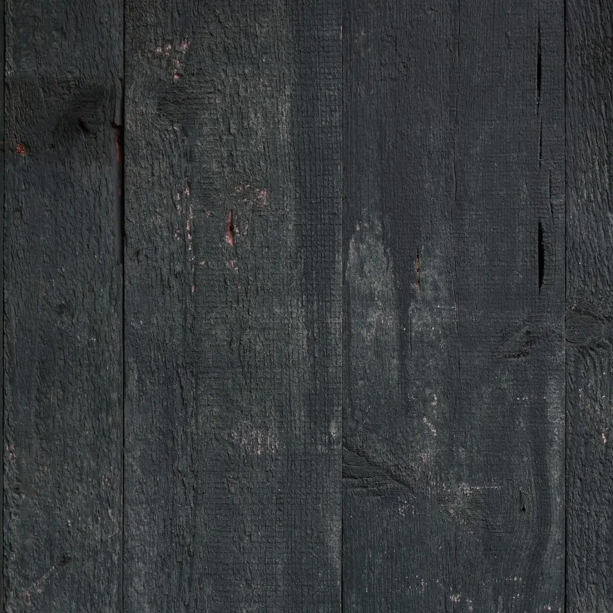 Rough-sawn boards painted pitch black