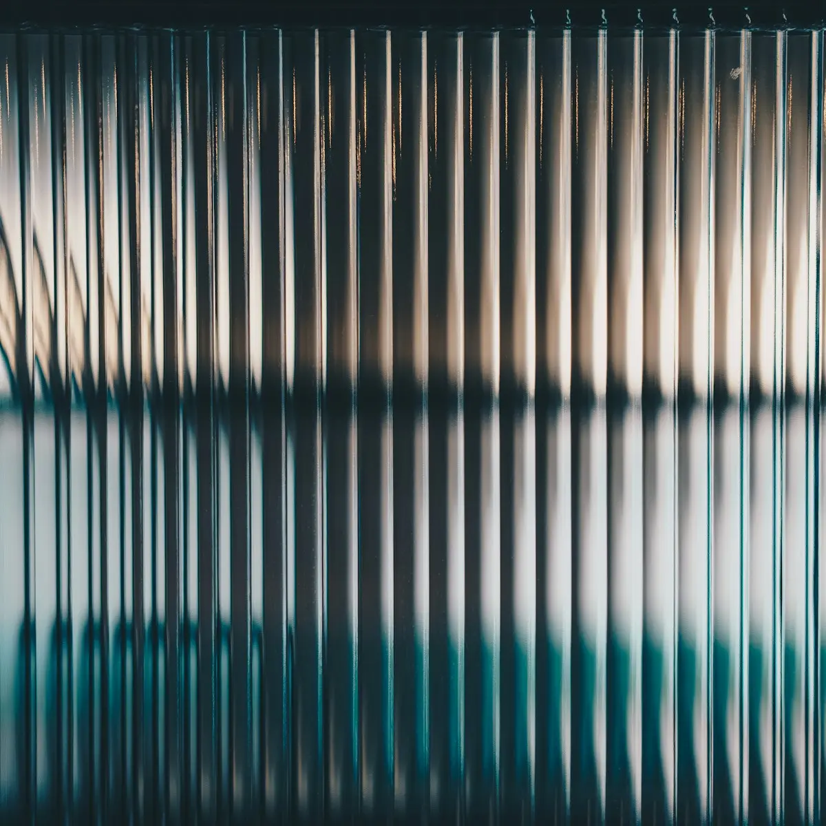Reeded glass with dark shapes behind