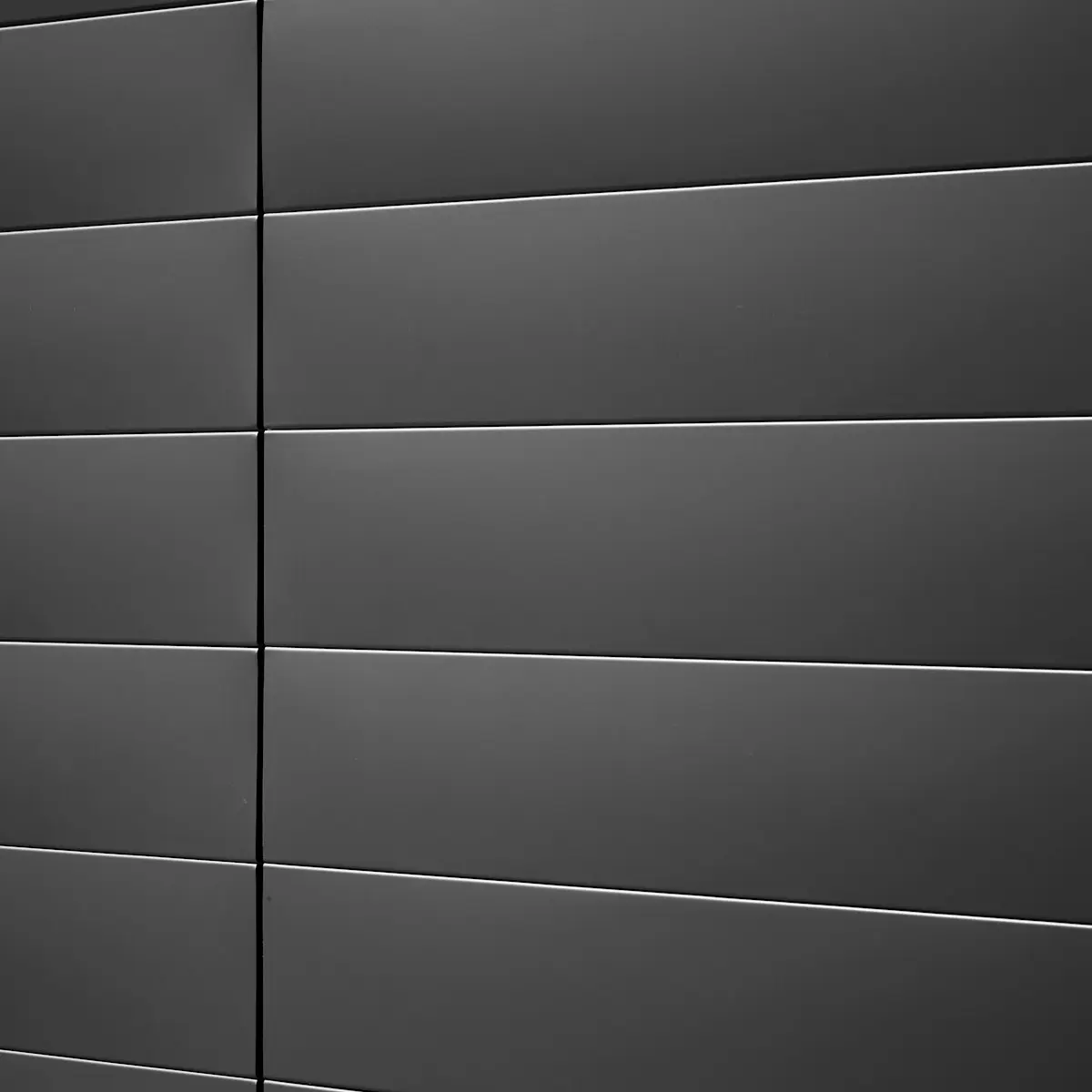 Dark charcoal zinc panels, horizontal seams