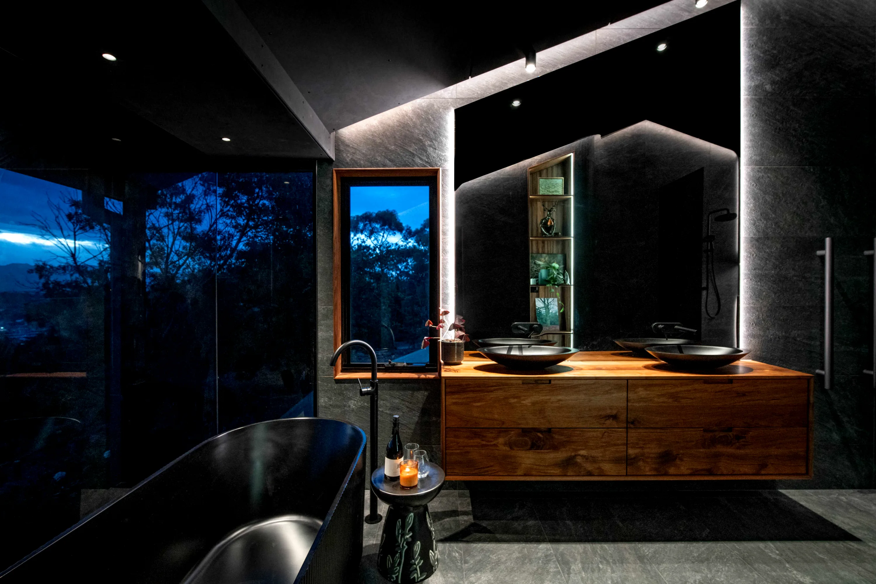 The Waverley bathroom — dark stone and controlled light in a renovated Tasmanian home